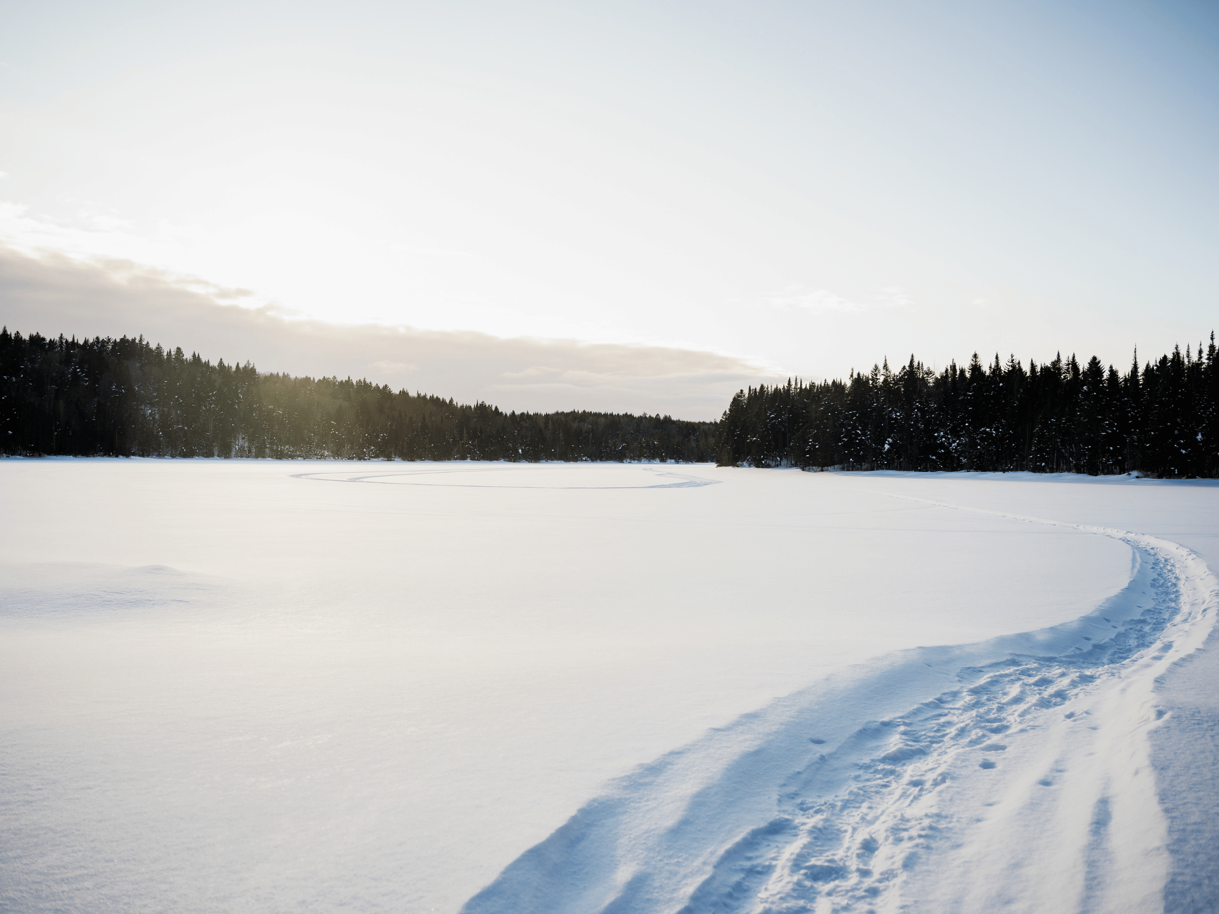 Paysage hivernal d’un lac gelé entouré de forêt à la Vallée Bras-du-Nord à Saint-Raymond dans Portneuf.